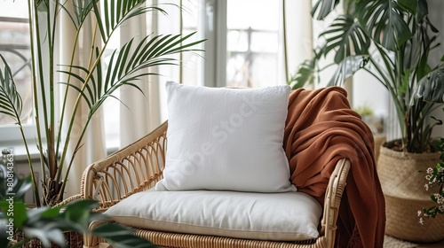 A blank linen pillowcase resting on a rattan chair, surrounded by colorful bohostyle throw blankets and indoor plants, ready for textile design showcasing photo