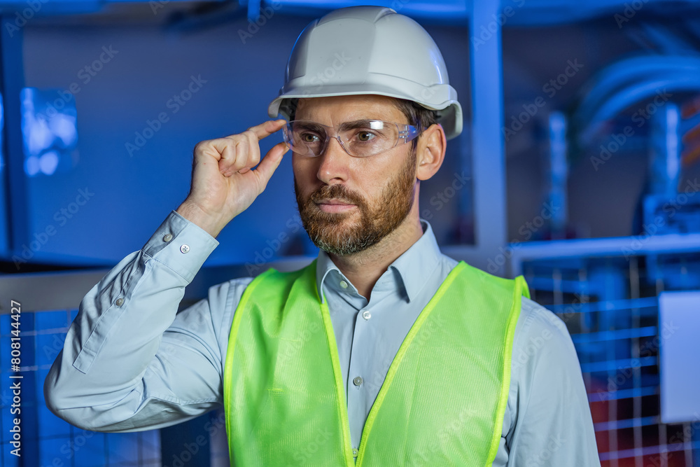 Portrait of Smiling Professional Industry Engineer / Worker Wearing Safety Uniform, Goggles and Hard Hat. Portrait of Smiling Professional Industry Engineer / Worker Wearing Safety Uniform, Goggles and Hard Hat.