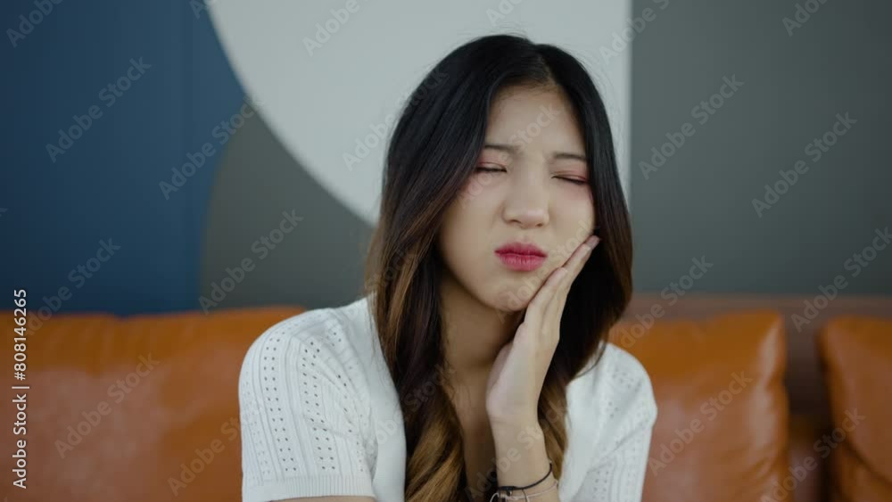 Toothache, Upset young asian woman touch cheek, suffers from toothache, girl having terrible sudden tooth pain at home, need dental treatment, pulpitis, gum disease concept, Health care and dental Toothache, Upset young asian woman touch cheek, suffers from toothache, girl having terrible sudden tooth pain at home, need dental treatment, pulpitis, gum disease concept, Health care and dental