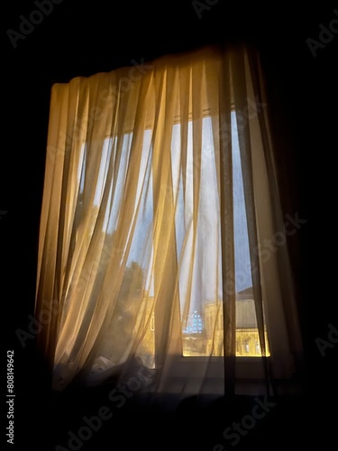 window with tulle in the evening romance