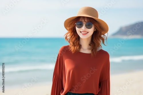 Cheerful asian traveler ready for holiday adventure in beach attire on blue background
