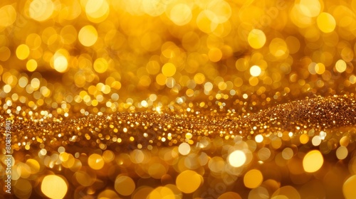  A tight shot of a golden glitter backdrop, featuring a soft, blurred depiction of light emanating from the picture's upper portion