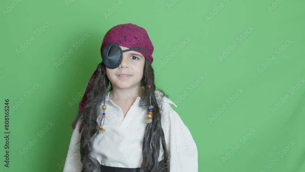costume party. Kute child in peirate costume posing over the green background. Slow motion with copy space. High quality 4k footage costume party. Kute child in peirate costume posing over the green background. Slow motion with copy space. High quality 4k footage
