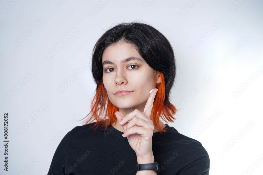 Mediterranean black and orange haired person showing a scoop of moisturizing cream on their index finger. Mediterranean black and orange haired person showing a scoop of moisturizing cream on their index finger.