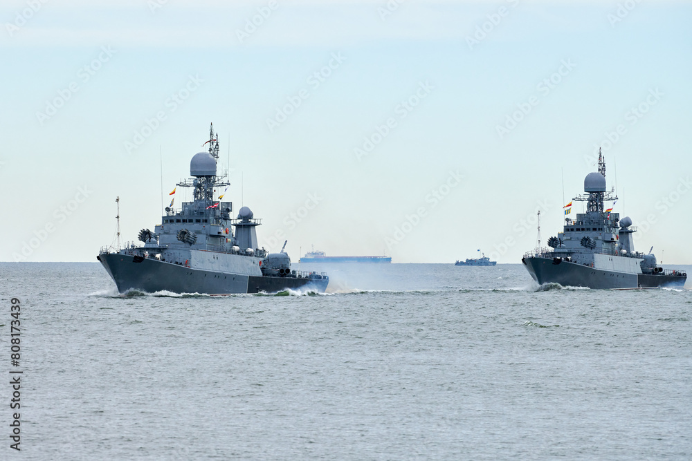 Flotilla of Russian warships sailing toward military target, armed warships ready for attack enemy performing strategic maneuver, Russian sea power deployment warships for tactical advantage