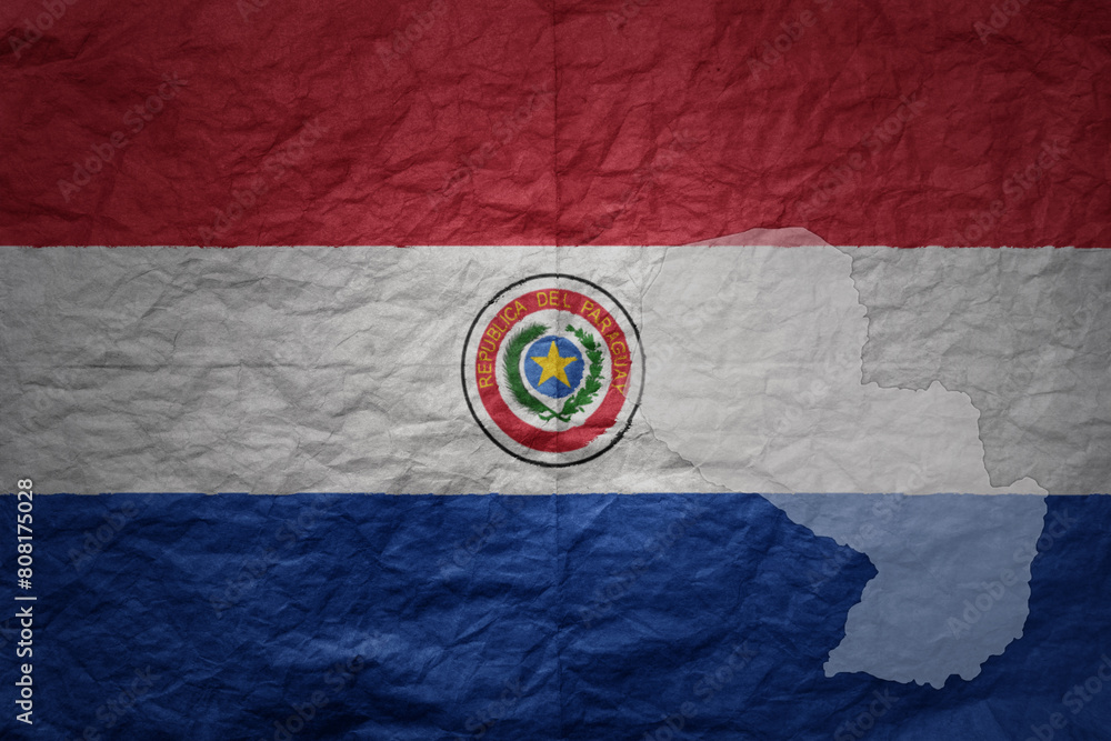 Naklejka premium big national flag and map of paraguay on a grunge old paper texture background