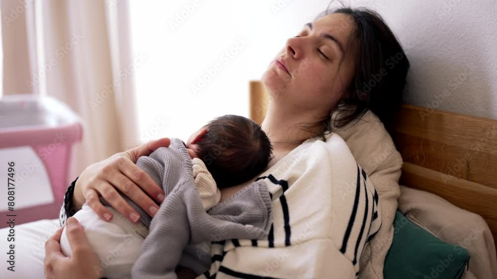 Exhausted Mother Laid in Bed with Newborn on Chest, Embracing During First Week of Life. Affectionate Maternal Scene. woman feeling fatigue, taking a nap Exhausted Mother Laid in Bed with Newborn on Chest, Embracing During First Week of Life. Affectionate Maternal Scene. woman feeling fatigue, taking a nap