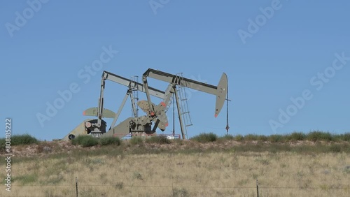 Bringing crude oil to the surface with two reciprocating plunger pumps.