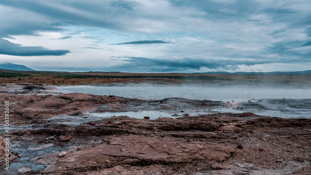 Geysir area. Steam vents, fumaroles and boiling mud pots. Panorama of suggestive volcanic landscape in the Golden Circle, Iceland. Geothermal area in Haukadalur.