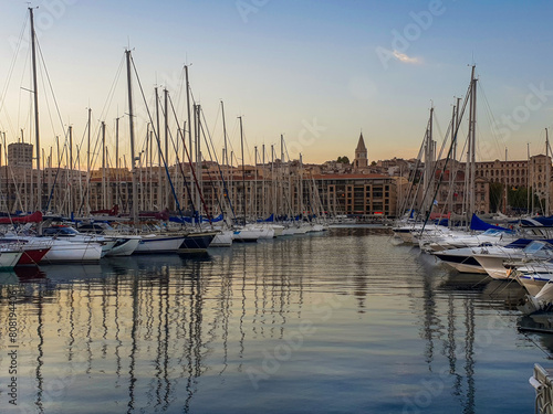 Amazing landscape  of  Vieux-Port of Marseille with nautical vessels and yachts, behind buildings of old city . Yellow sunset !