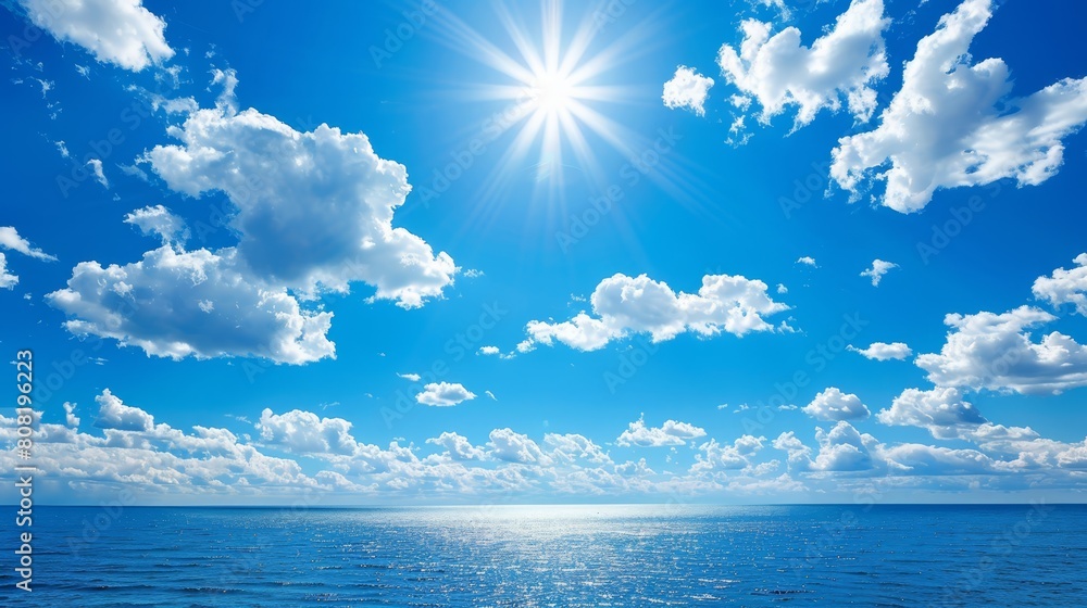 The sun shines brightly in the blue sky above the ocean on a sunny day Blue skies hold white clouds The sun shines brightly in the blue sky above the ocean on a sunny day Blue skies hold white clouds