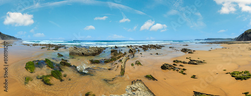 Rock formations on sandy beach (Algarve, Costa Vicentina, Portugal). 