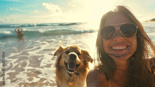 A happy woman and her faithful dog enjoy playing on the sandy beach while basking in the warm sunshine. © Pavel Lysenko