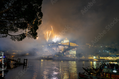 colorful beautiful fireworks over douro river in porto portugal on sao joao festival photo