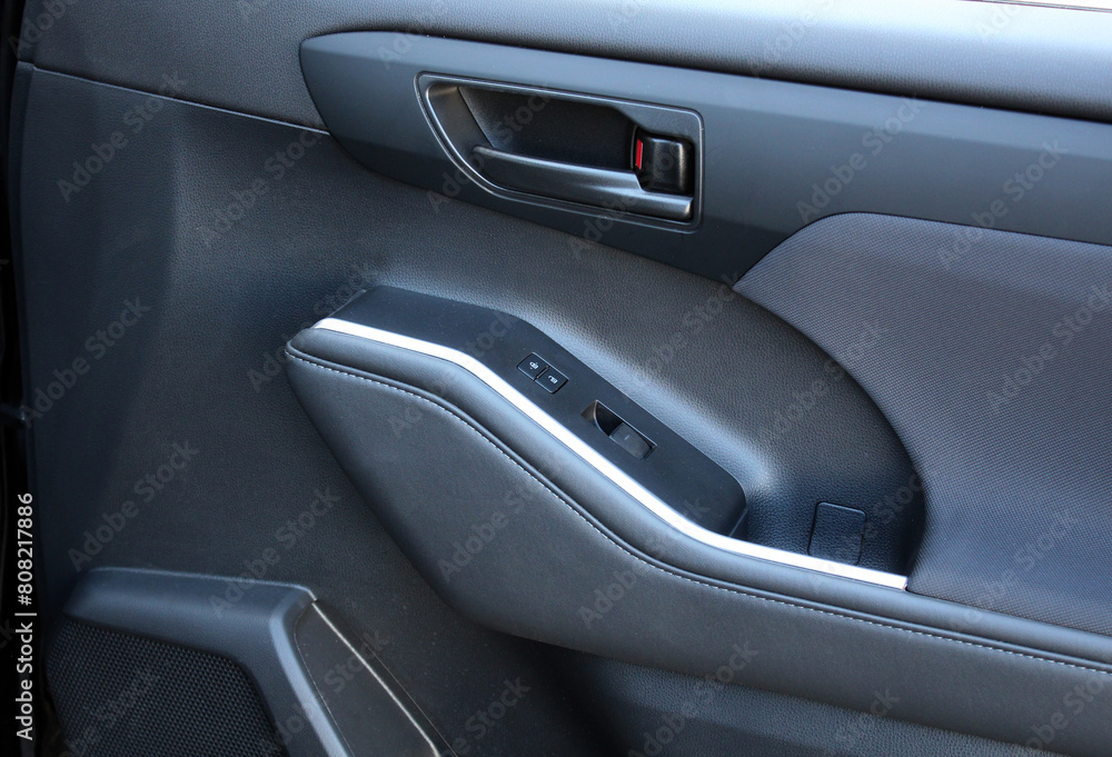 Premium SUV inside door handle. SUV door control panel. Window lifters control. Armrest with setting adjustment button and blocking the opening and closing of doors. Door trim.