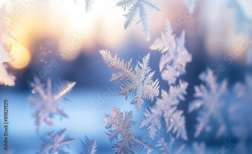 Frost patterns on a windowpane during a chilly morning.