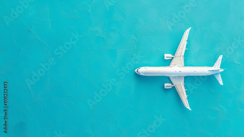 A white airplane is flying over a blue ocean