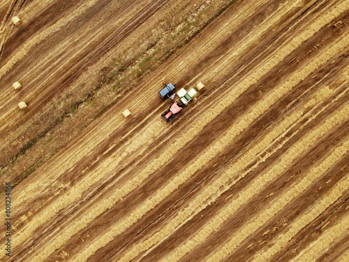 Tilling the Earth: Aerial View 4K UHD image Background of Tractor Plowing the Field for Seasonal Land Cultivation