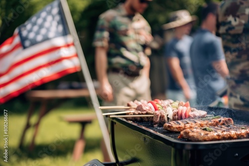 Friends gather for a barbecue with an American flag in the background, symbolizing a military community event. 4th of July, american independence day, memorial day concept © evgenia_lo
