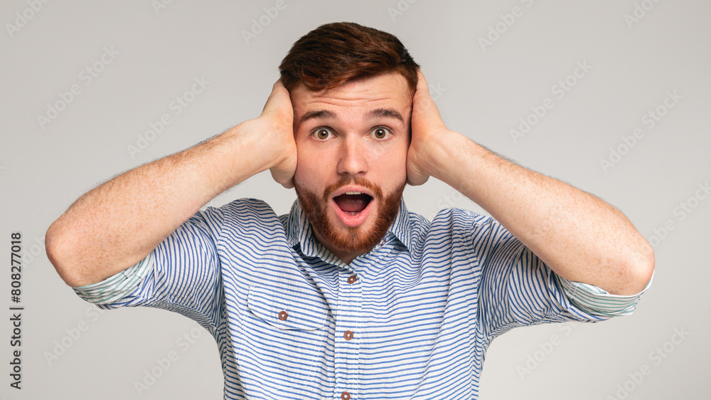 Angry with nosy neighbors. Portrait of irritated man shouting and covering his ears on studio background, panorama Angry with nosy neighbors. Portrait of irritated man shouting and covering his ears on studio background, panorama