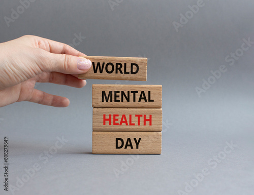 World Mental Health Day symbol. Wooden blocks with words World Mental Health Day. Businessman hand. Beautiful grey background. Health concept. Copy space.