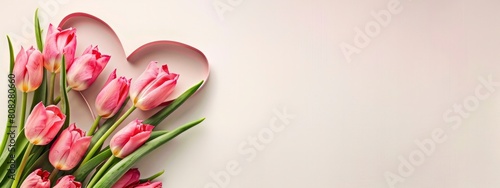 heart shaped cutout with pink tulips on a corner of light pink background #808280660