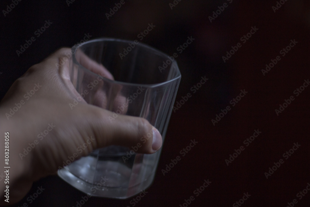 hand holds glass glass with liquid, alcohol hand holds glass glass with liquid, alcohol