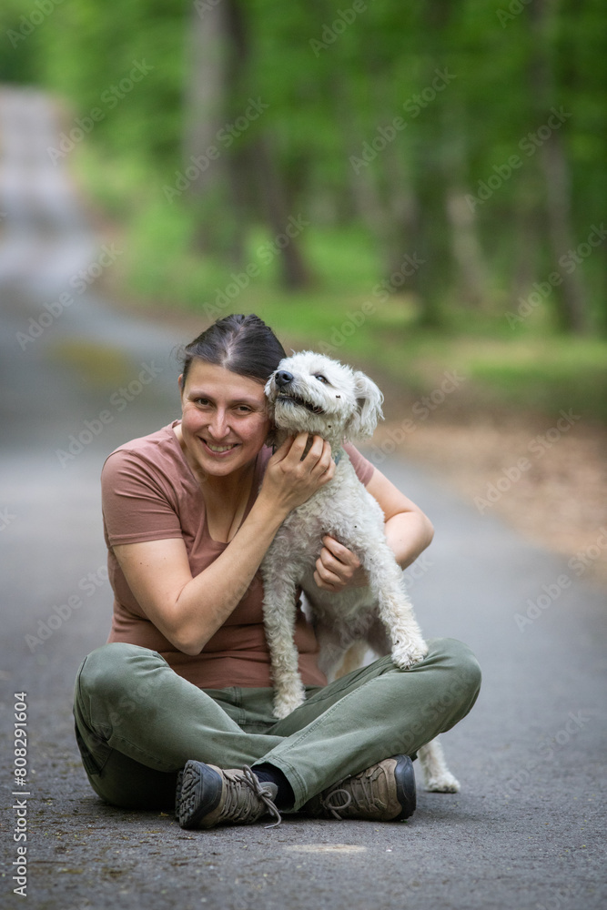 happy woman with her dogs in the forest