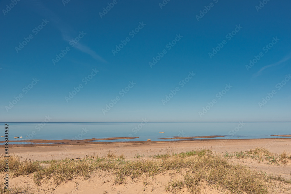 Empty sandy beach of Baltic sea at sunny spring day