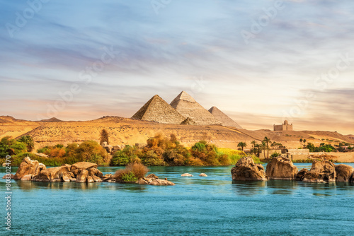 The Nile river and ancient rocks in the Aswan desert by the pyramids, Egypt