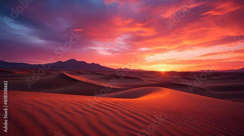 Desert dunes panorama at sunset with red and orange colors