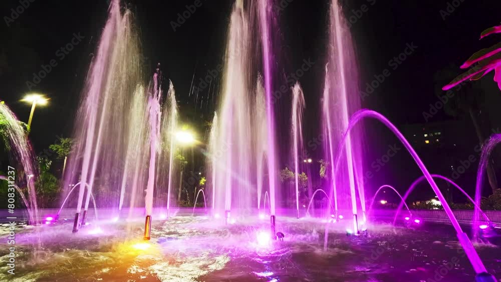 Multicolored water fountain in a city center square in Brazil Multicolored water fountain in a city center square in Brazil