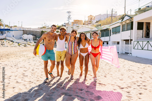 Multiracial group of young tourist friends having fun at beach during vacation