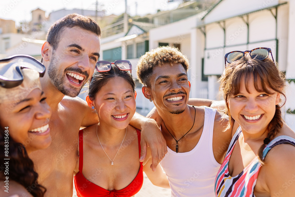 Fototapeta premium Happy diverse group of friends enjoying summer holiday at beach. Vacation lifestyle concept