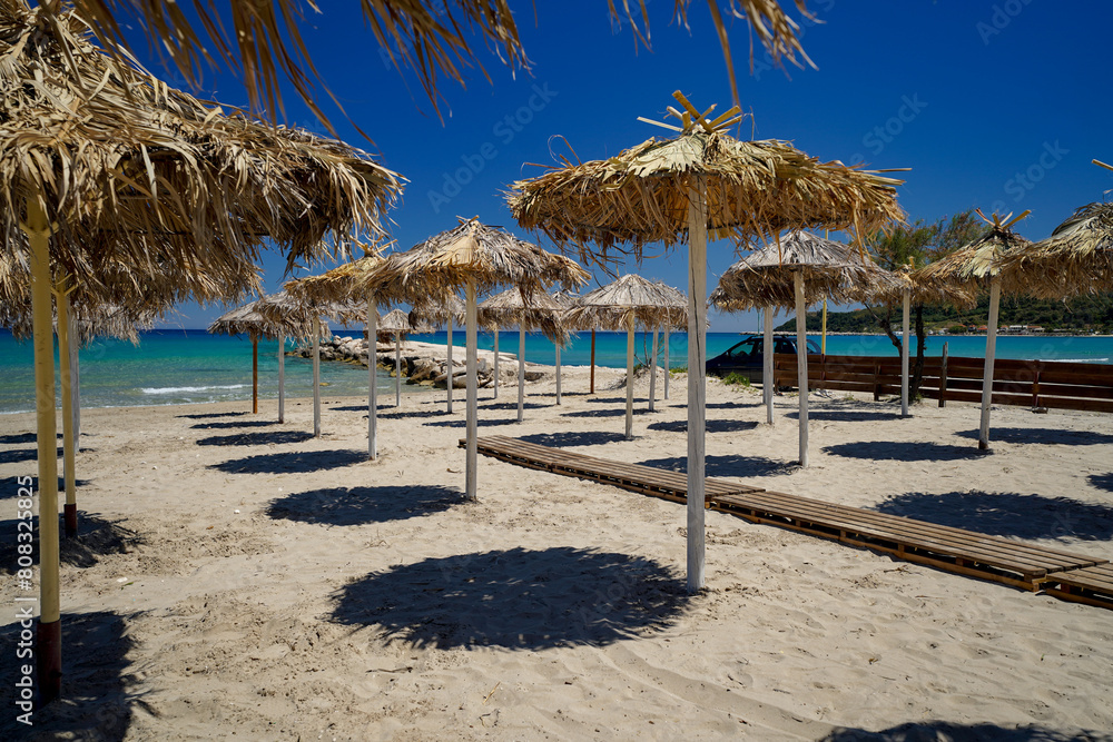 sun umbrellas on sand beach of Alykes