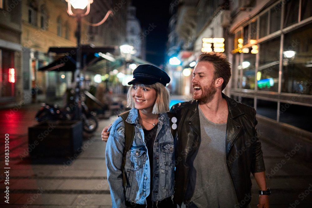 Loving couple enjoying a romantic evening stroll in the city Loving couple enjoying a romantic evening stroll in the city