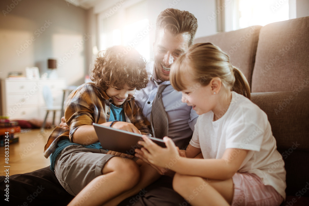 Happy father playing with son and daughter at home Happy father playing with son and daughter at home
