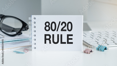 Text The 80 20 Rule written on the notebook on office table photo