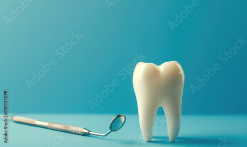 Model of a tooth and dental instruments. Dentistry concept background