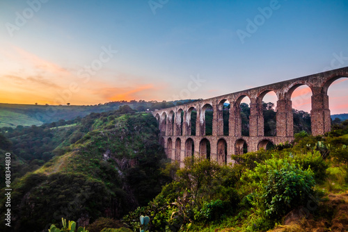 Sunrise with colored sky in aqueduct of the site arches in tepotzotlan state of Mexico photo