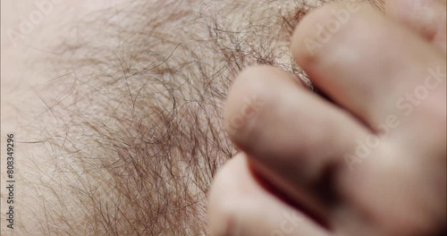 Scratch hairy male chest. Stroking a part of the body with the hand. photo