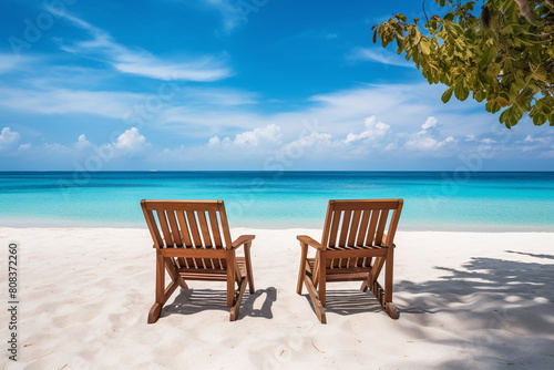 Two wooden chairs facing a calm turquoise sea on a bright sunny day  with white sand under clear blue skies - Generative AI