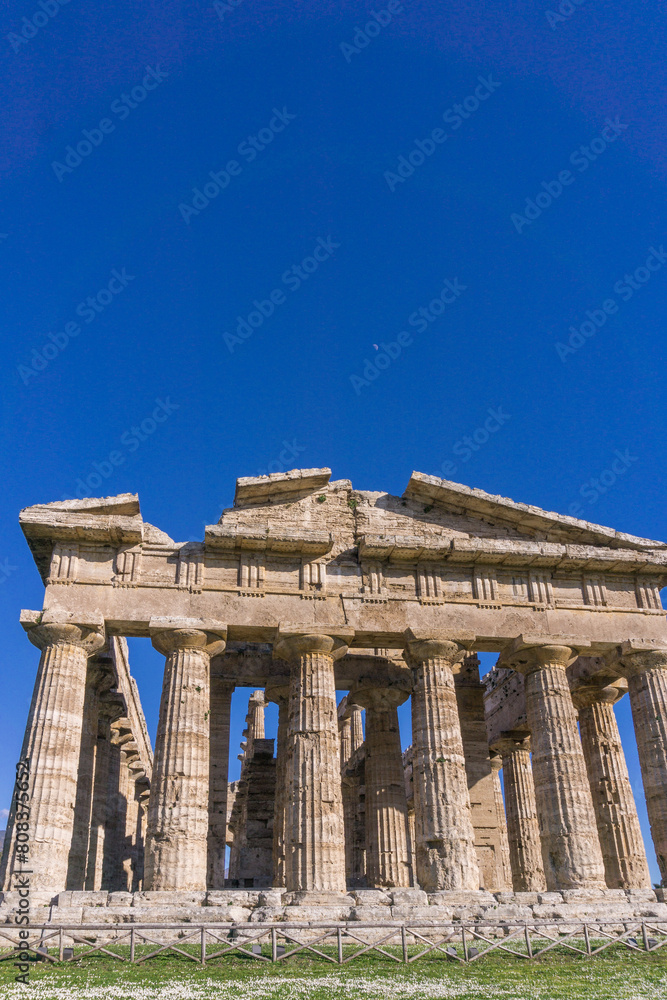 Naklejka premium Detail view of Temple of Hera with moon above at famous Paestum Archaeological UNESCO World Heritage Site, Province of Salerno, Campania, Italy