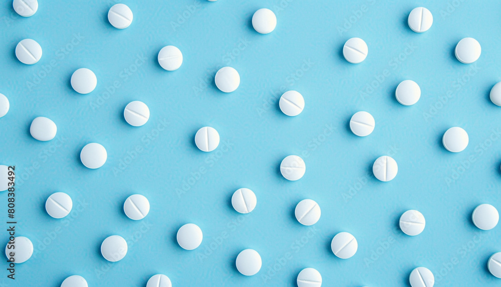 Many antibiotic pills on light blue background
