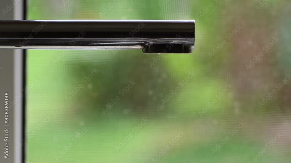 Medium shot kitchen sink tap, faucet slowly dripping next to window green blurry bokeh background copy space Medium shot kitchen sink tap, faucet slowly dripping next to window green blurry bokeh background copy space