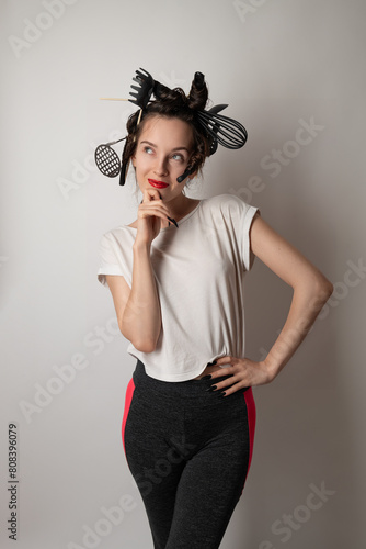 beautiful brunette housewife girl with kitchen utensils in her hair instead of curlers