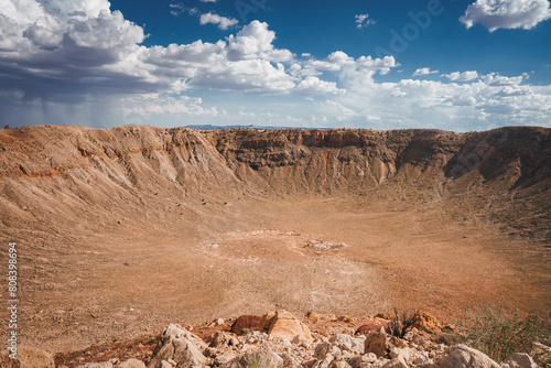 Impressive Meteor Crater, Barringer Crater, Arizona, USA. A geological landmark formed by a meteorite impact 50,000 years ago. Arid desert terrain, steep walls, sparse vegetation. photo