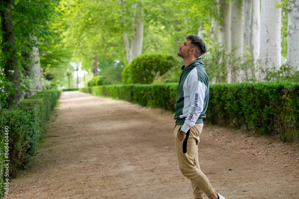 Embrace the active lifestyle with style as he rocks a sleek athletic ensemble, soaking in the scenic beauty of the park Embrace the active lifestyle with style as he rocks a sleek athletic ensemble, soaking in the scenic beauty of the park