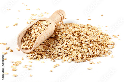 Raw organic oat flakes in wooden spoon on portion of oats isolated on white background. Photography for packaging