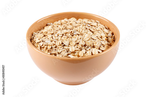 Raw organic oat flakes in ceramic bowl on portion of oats isolated on white background. Photography for packaging